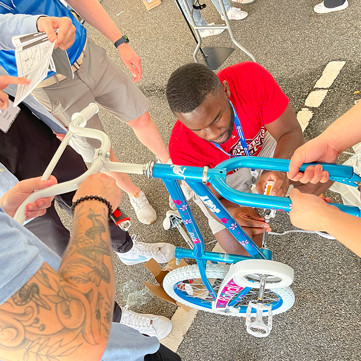 People assembling a bike during a team building event