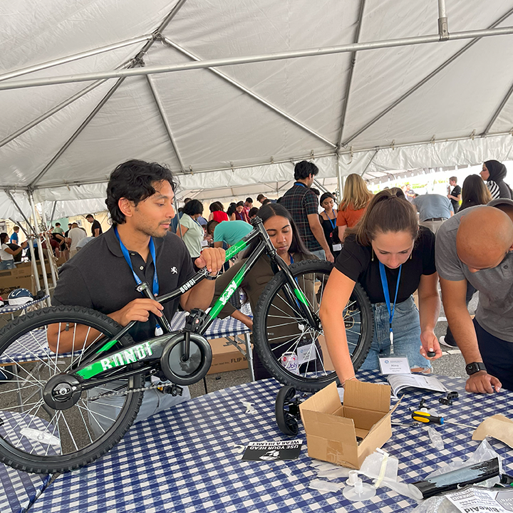 People putting together a bike during a team building event