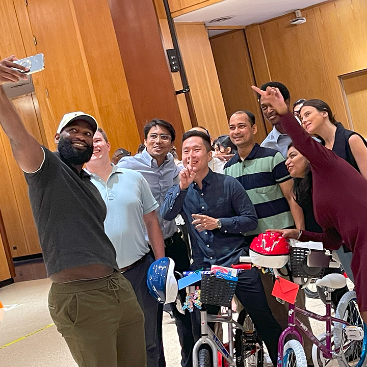 Team Building event people taking a selfie of themselves and the bikes they have built for charity.