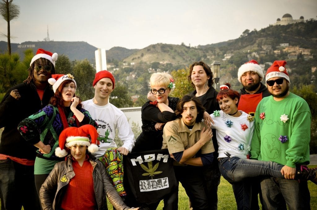 Group of people giving pose by wearing Christmas hats.