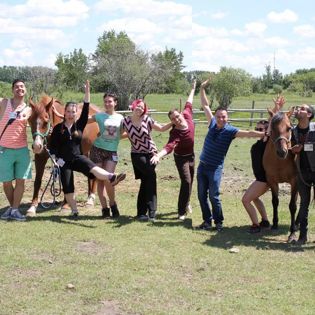 Employees pose for a picture during summer outdoor team building