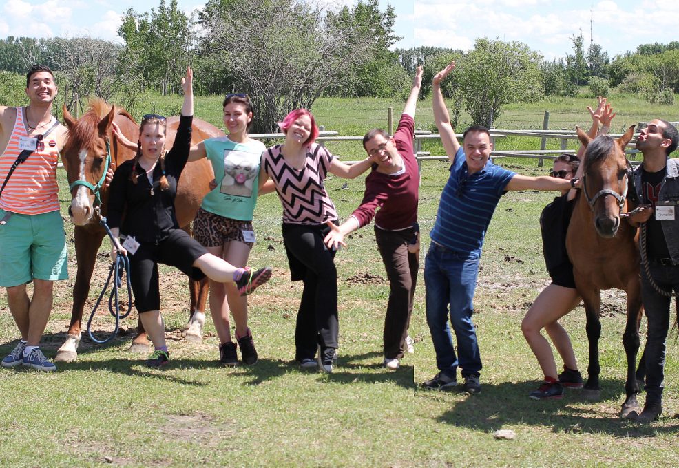 Employees pose for a picture during summer outdoor team building