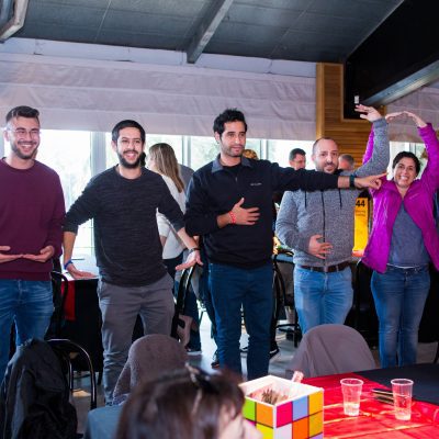 A group of participants actively participates in a team building activity, working together in a fun, collaborative task involving movement and problem-solving. thumbnail