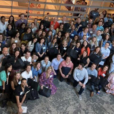 Large group photo from a successful Hopefull Handbags Global team building event, where participants gathered to prepare donations for survivors of domestic abuse. thumbnail