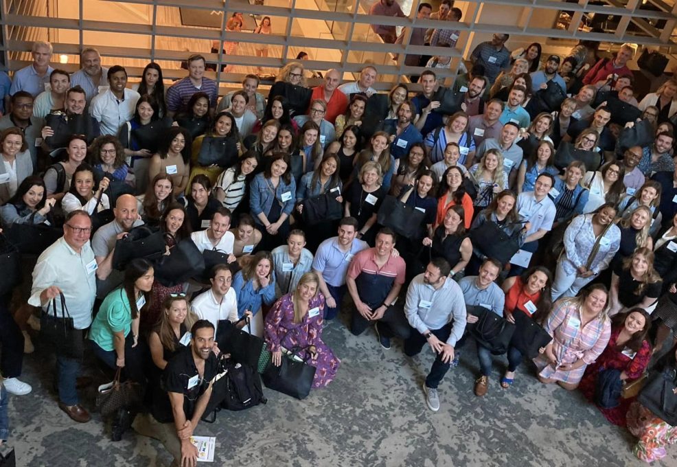 Large group photo from a successful Hopefull Handbags Global team building event, where participants gathered to prepare donations for survivors of domestic abuse.