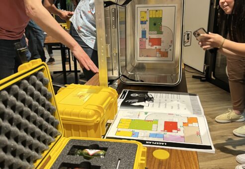 Participants working together to solve puzzles during the 'Atmosphere' team building event, unlocking boxes to find the missing elements for creating a livable atmosphere on Mars.