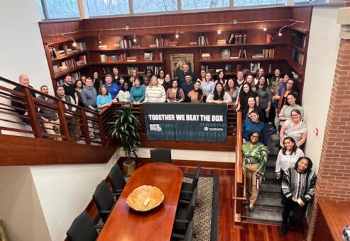 Group photo of participants celebrating their success in the Beat the Box team building event, highlighting teamwork and collaboration in solving the mind-bending challenges together.