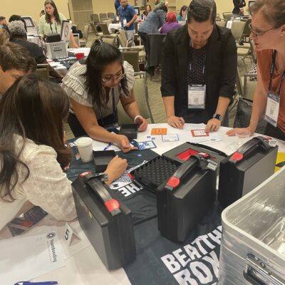Team intensely solving escape room-style puzzles during the Beat the Box team building event, fostering collaboration and critical thinking. thumbnail