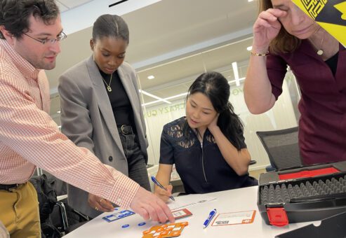 Team collaborating closely to solve puzzles during the Beat The Box team building event, focused on unlocking the next challenge.