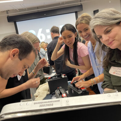 Focused participants work together to crack codes and solve puzzles during the Beat The Box team building event, racing against the clock to unlock the next challenge. thumbnail
