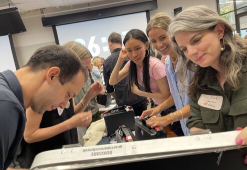 Focused participants work together to crack codes and solve puzzles during the Beat The Box team building event, racing against the clock to unlock the next challenge.