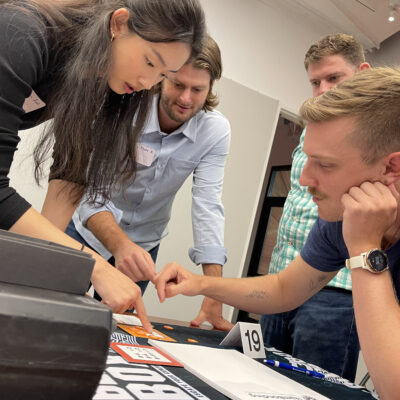 Focused team members work together to solve a puzzle during the high-energy Beat The Box team building event, showcasing their problem-solving skills and collaboration. thumbnail