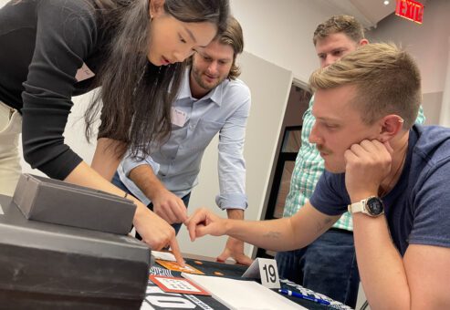 Focused team members work together to solve a puzzle during the high-energy Beat The Box team building event, showcasing their problem-solving skills and collaboration.