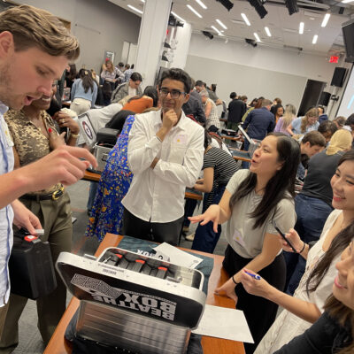 Enthusiastic participants engage in solving complex puzzles during the Beat The Box team building event, working against the clock to unlock clues and achieve success together. thumbnail