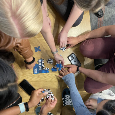 Team members piece together a puzzle as part of the Beat the Box team building activity, fostering collaboration and problem-solving skills to complete the challenge. thumbnail