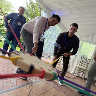 Participants working together in the Integrity team building event, using colorful ropes to complete a physical challenge while focusing on collaboration. thumbnail