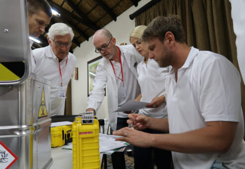 Team collaborating to solve puzzles and unlock clues during the 'Atmosphere' team building event, focused on creating an artificial atmosphere for Mars.