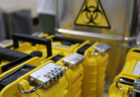 Yellow lockboxes with combination locks and biohazard symbols used in the 'Atmosphere' team building event.