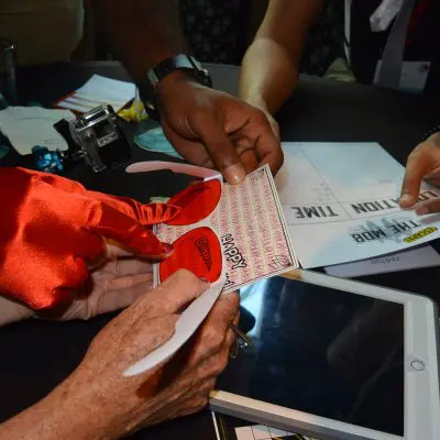 Participants in the Escape the Mob event collaborate on a clue while working to solve the high-tech scavenger hunt and crack the case of the missing diamonds. thumbnail