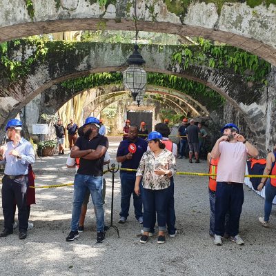 Outdoor team building activity with participants wearing hard hats and safety gear. Teams collaborate to complete a challenge, emphasizing communication, problem-solving, and teamwork in a dynamic setting. thumbnail