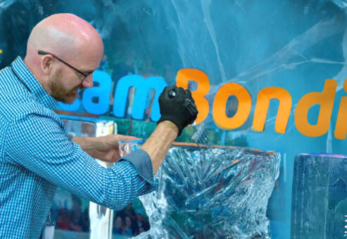 A participant works on an ice sculpture while taking part in a Team building Ice Sculpting event, showcasing creativity and teamwork.