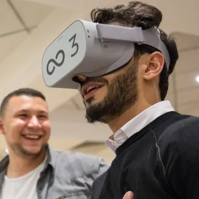 Participant wearing a VR headset during The Infinite Loop team building event, immersed in a virtual world challenge. The activity promotes communication, collaboration, and problem-solving as teams work together to solve challenges in the virtual realm. thumbnail