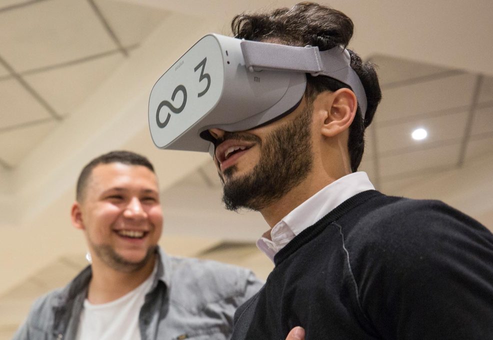 Participant wearing a VR headset during The Infinite Loop team building event, immersed in a virtual world challenge. The activity promotes communication, collaboration, and problem-solving as teams work together to solve challenges in the virtual realm.