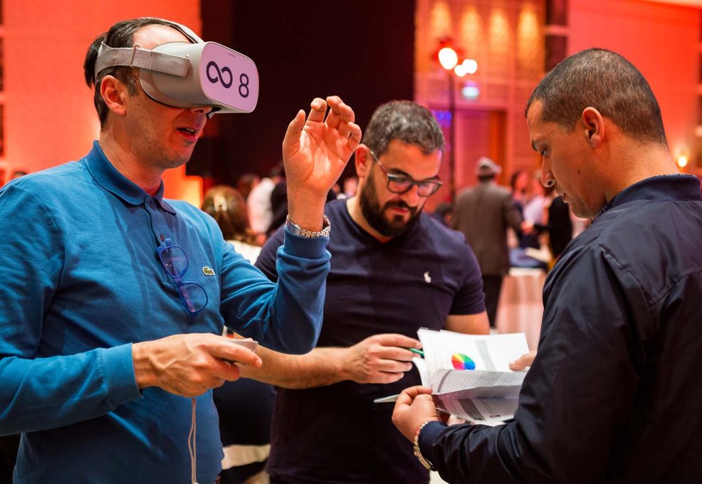 Participant wearing a VR headset during The Infinite Loop team building event, collaborating with teammates to solve virtual challenges. The event emphasizes teamwork, communication, and problem-solving in a virtual reality setting.