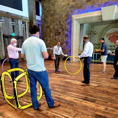 Participants navigate drones through colorful hoops in an interactive and competitive challenge during the Game of Drones team building event. thumbnail