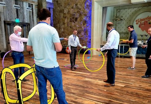 Participants navigate drones through colorful hoops in an interactive and competitive challenge during the Game of Drones team building event.