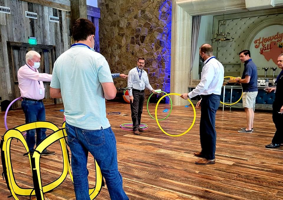 Participants navigate drones through colorful hoops in an interactive and competitive challenge during the Game of Drones team building event.