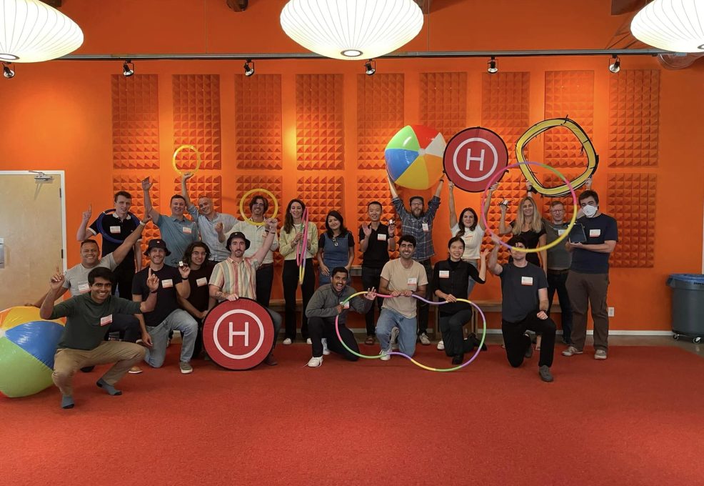 A group celebrates their success in the Game of Drones team building event, posing with drone-themed props and showcasing the power of teamwork and fun competition.