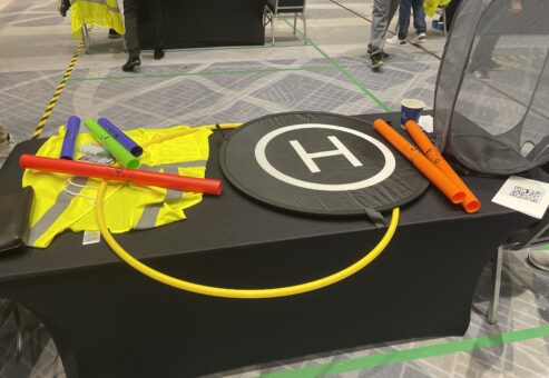 Colorful props, landing pads, and tools are set up for participants to navigate their drones during the Game of Drones team building event.