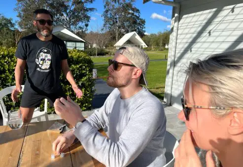 Team members participating in a fun outdoor team building activity, collaborating and strategizing. The event encourages teamwork, communication, and friendly competition in a relaxed setting.