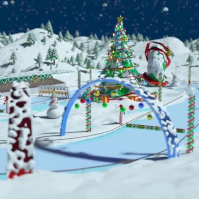 Snowy racetrack decorated with candy canes and Christmas lights, featuring a large Christmas tree, snowmen, and holiday-themed arches from the Reindeer Games team building event. thumbnail