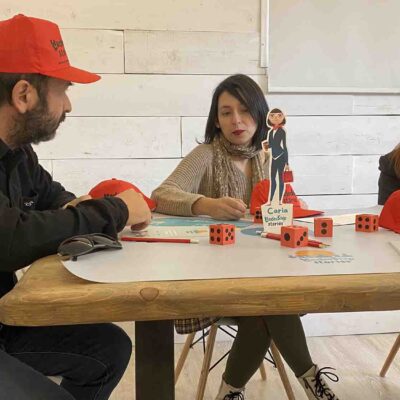 Team members collaborating during the Leadership Stories event, discussing and making strategic decisions while playing the game. thumbnail