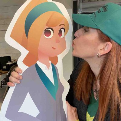 A participant playfully kisses the Leadership Stories character during a fun moment of the event, engaging in team collaboration and leadership exercises. thumbnail