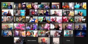A virtual meeting grid with participants holding colorful balloons, showcasing a lively and festive atmosphere.