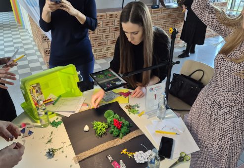 Stop motion animation team building activity. Participants collaborate to create a short film using props and careful frame-by-frame adjustments, emphasizing creativity, teamwork, and communication.