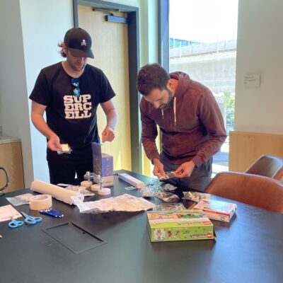 Two participants organizing materials and planning for their stop motion animation project during a team building event. thumbnail