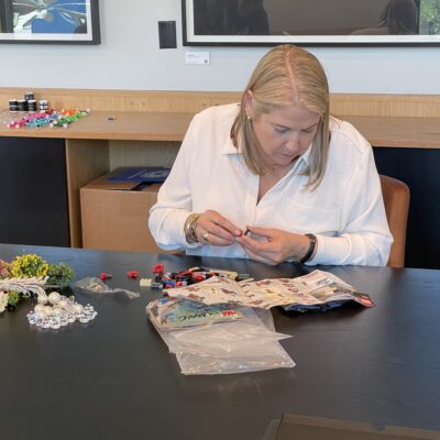 Participant assembling small pieces for a creative stop motion animation project during a team building activity. thumbnail