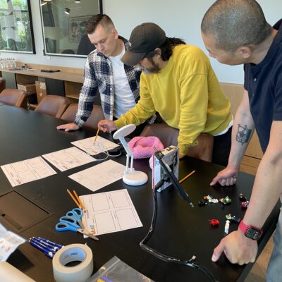 Team members collaborating on a storyboard for a stop motion animation project during a creative team building event. thumbnail