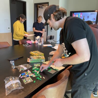 Team member assembling small brick pieces for a stop motion animation project during a hands-on team building event. thumbnail