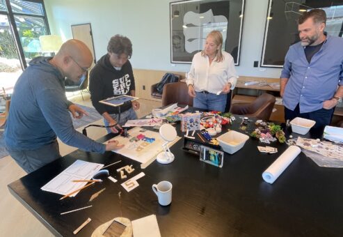 Team collaborating on crafting props for a stop motion animation project during a creative team building event.