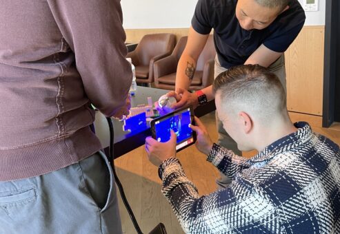 Team members capturing footage for a stop motion animation film during a hands-on team building event.