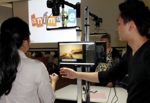 Team members filming a stop motion animation scene during a team building event focused on creativity and collaboration.