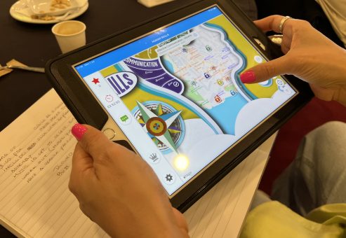 Close-up of a participant using a GPS-enabled tablet during a human skills team building activity. The interactive challenge encourages teamwork, strategic thinking, and problem-solving.