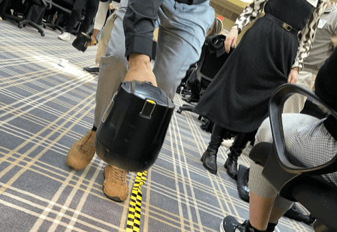 A participant watches intently as their STEM-built car crosses the finish line during the STEM Speedway race at a team building event.