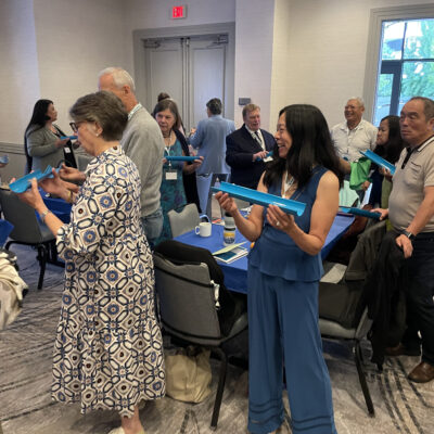 Participants working together to complete a challenge the 'Clean Water Connection' team building event. thumbnail