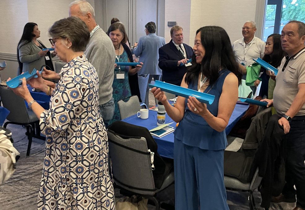 Participants working together to complete a challenge the 'Clean Water Connection' team building event.
